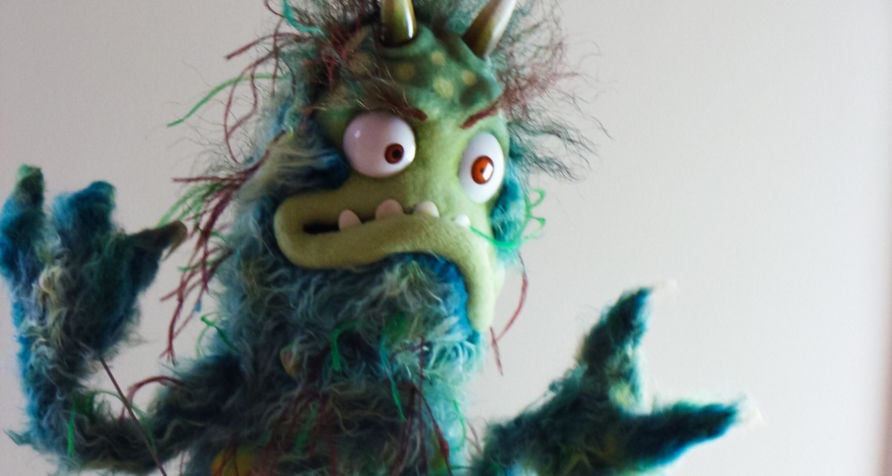 Monster puppet inspired by a bacteria, with wild expression and green fur