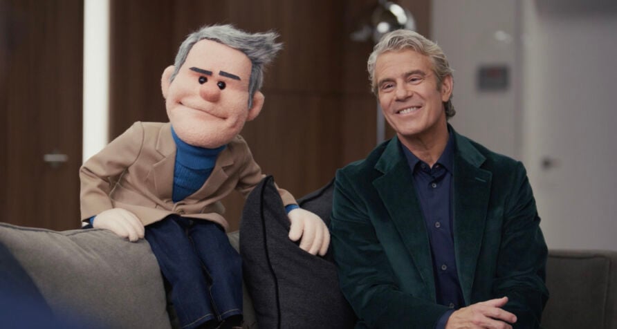 Custom puppet of Andy Cohen and actual Andy Cohen sitting together.