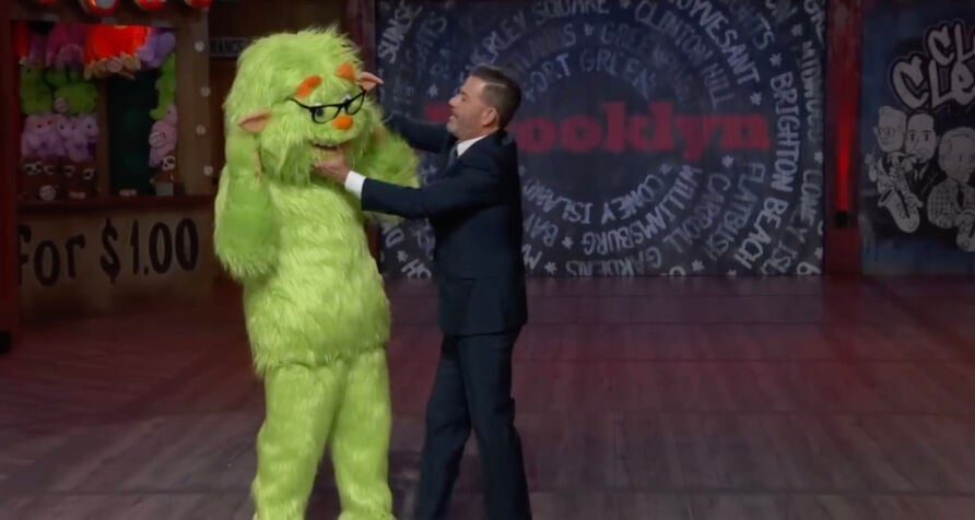 Jimmy Kimmel, removing a mascot costume head from Matt Damon