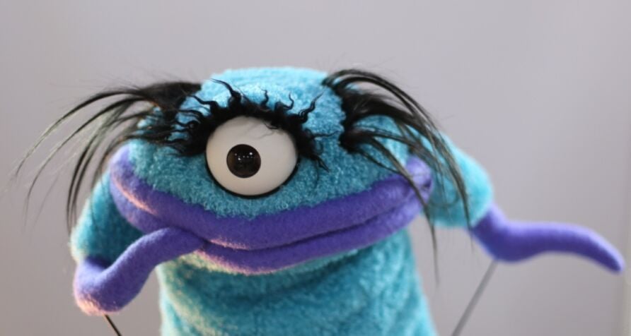Blue monster puppet with one eye