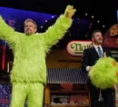 Jimmy Kimmel, removing a mascot costume head from Matt Damon